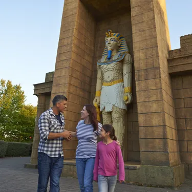 Family next to large Pharaoh model in Kingdom of the Pharaohs
